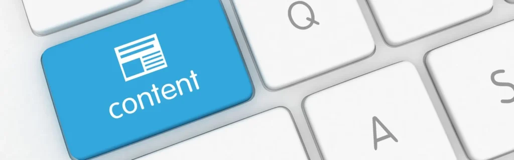 Teclat blanc amb una tecla blava de 'contingut', simbolitzant la creació de continguts digitals i blogs
